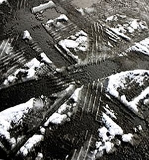 snowy tire tracks on pavement