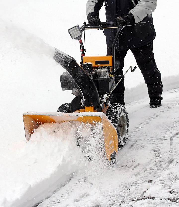 man using snow blower